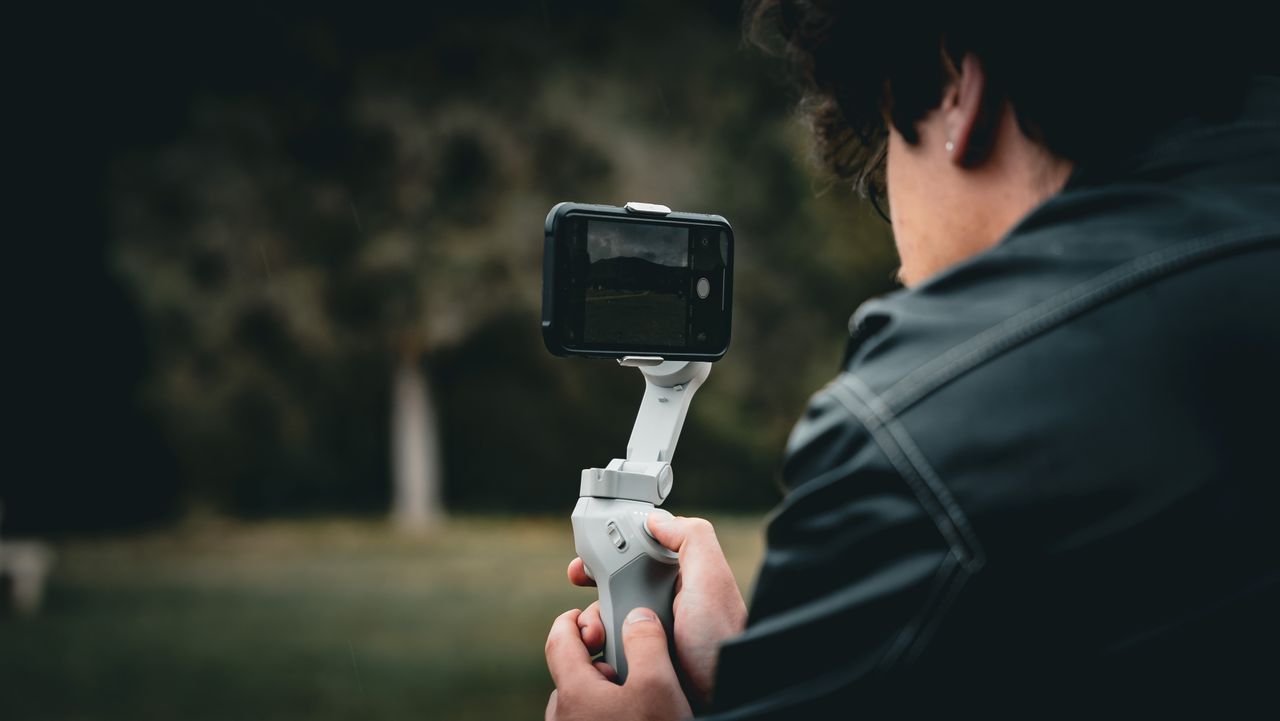 A person filming a scene with an iPhone